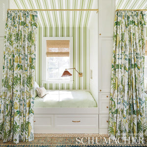 Custom-made curtains in high-end, designer Schumacher Tropique fabric created in our professional workroom by one of our expert craftsman. This painterly tropical pattern in the colors citron, blush & document creates the dream slumber party space in this bunk room.  Also available as a wallcovering.  